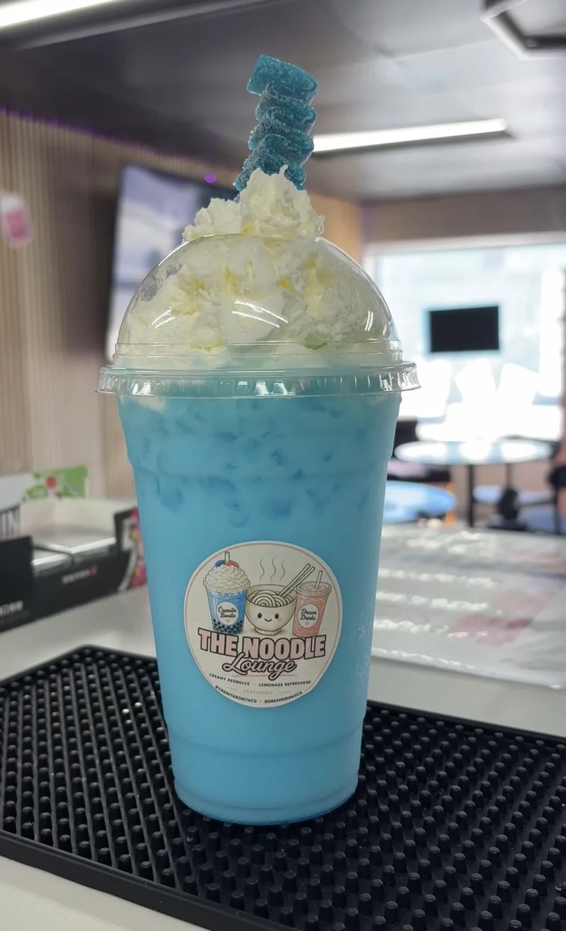 Creamy Blue Redbull topped with whipped cream and blue rock candy