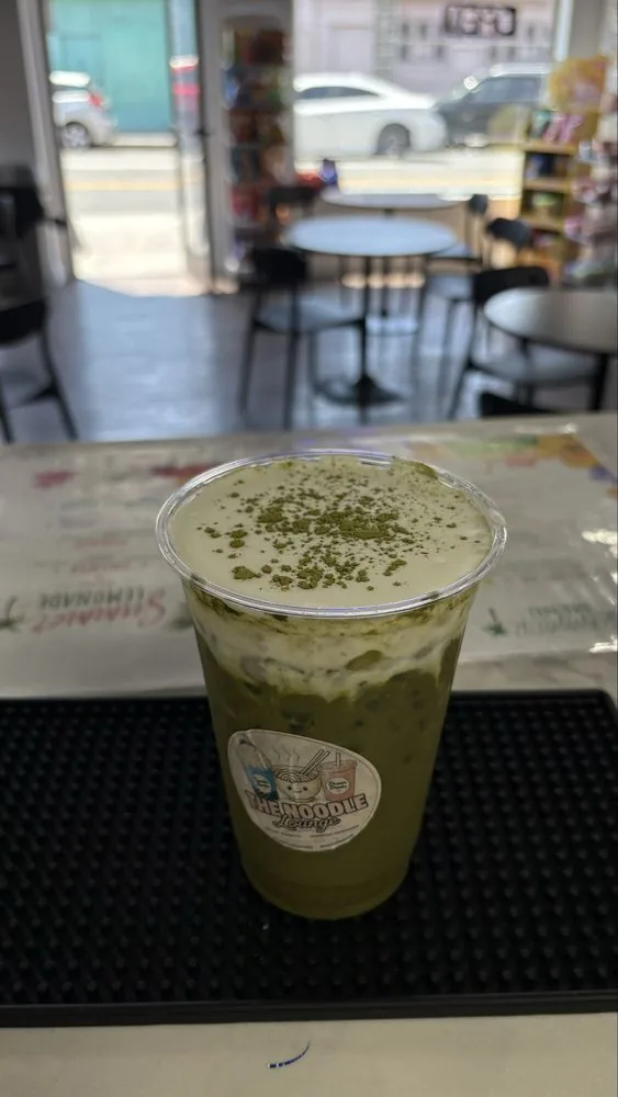 Iced matcha latte dusted with matcha powder
