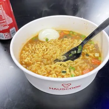 A spicy ramen bowl with a soft egg, fresh off the cooking station